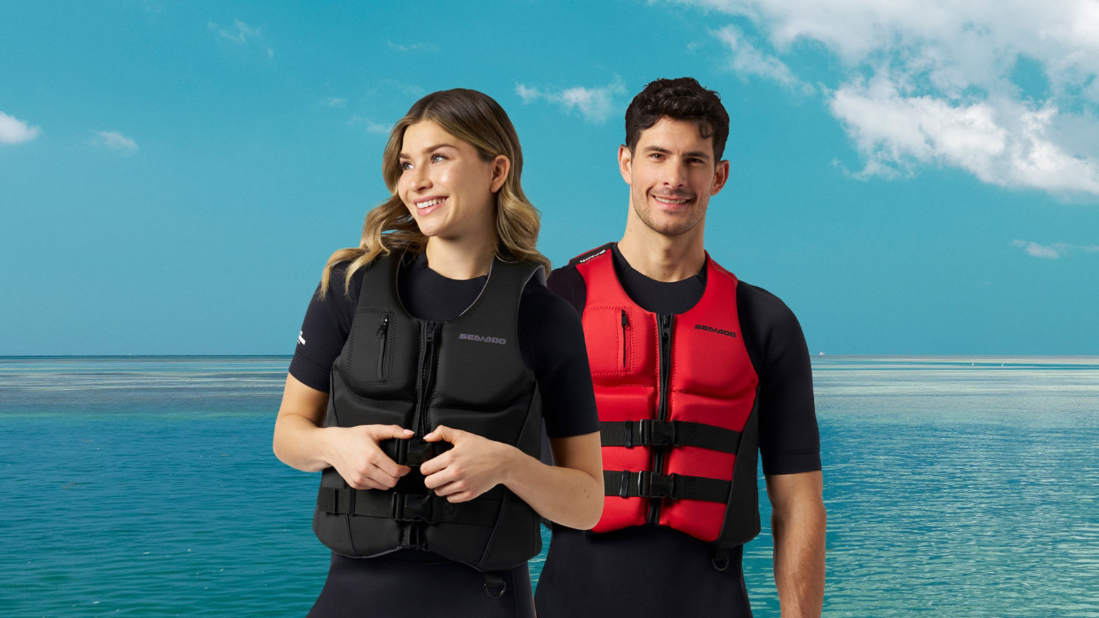 A man and a woman wearing their Sea-Doo personal flotation devices