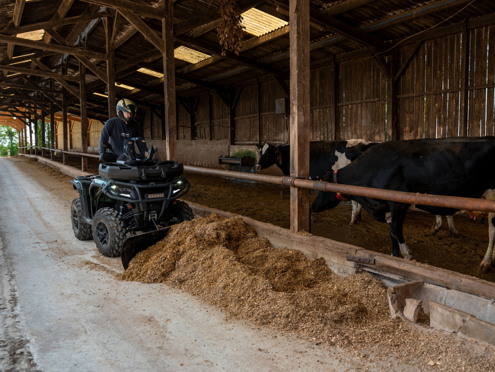 Farmer using an ATV Outlander equipped with a steel plow kit