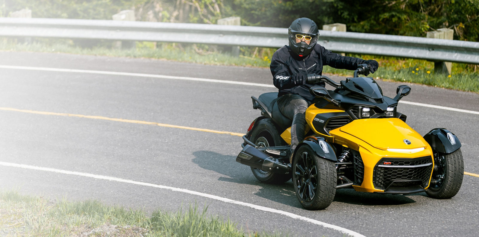 Men riding a yellow Can-am ryker