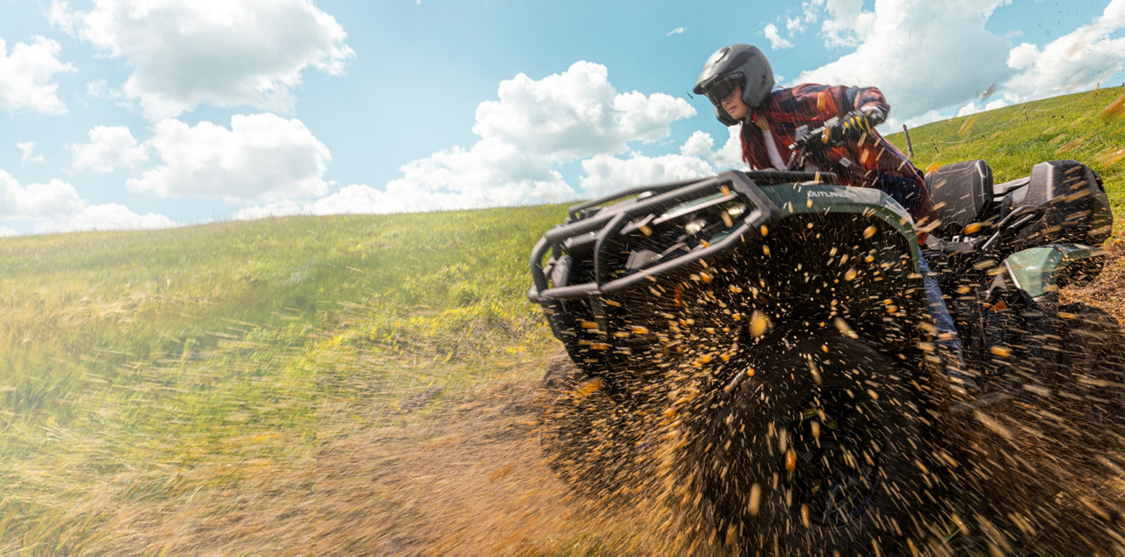 Women driving a can-am outlander ATV in mud