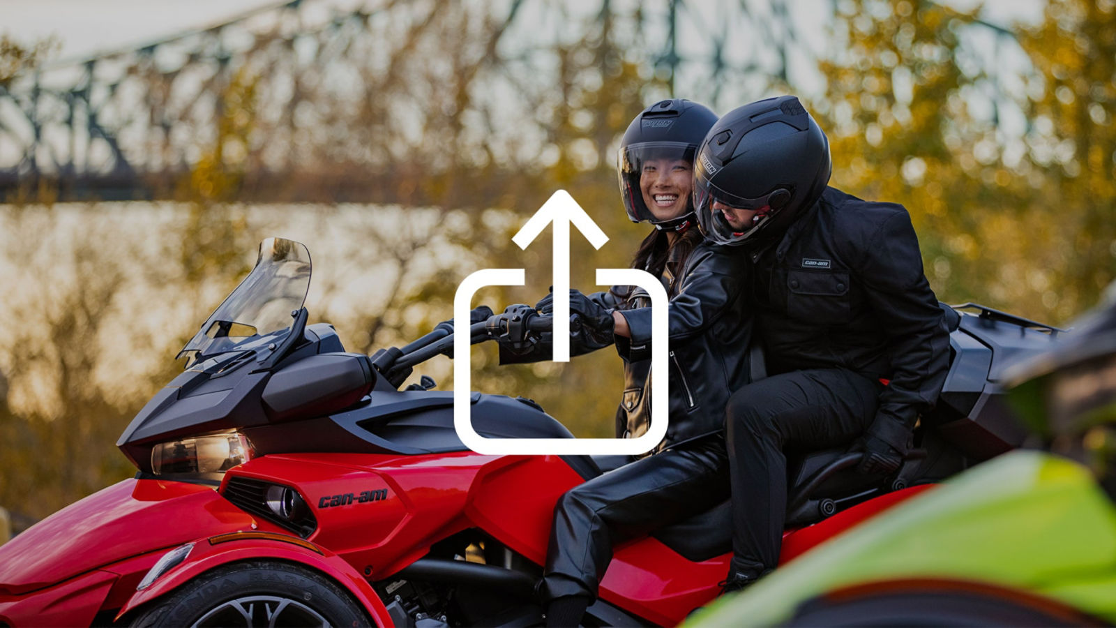 2 riders smiling on a Can-Am 3 Wheel Spyder F3