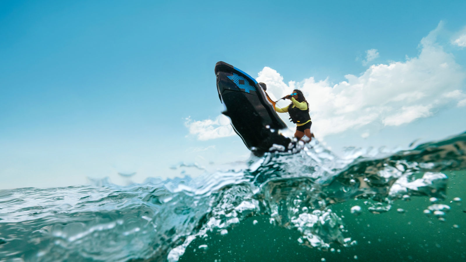 Woman performing a stunt with a Sea-Doo Spark Trixx personal watercraft
