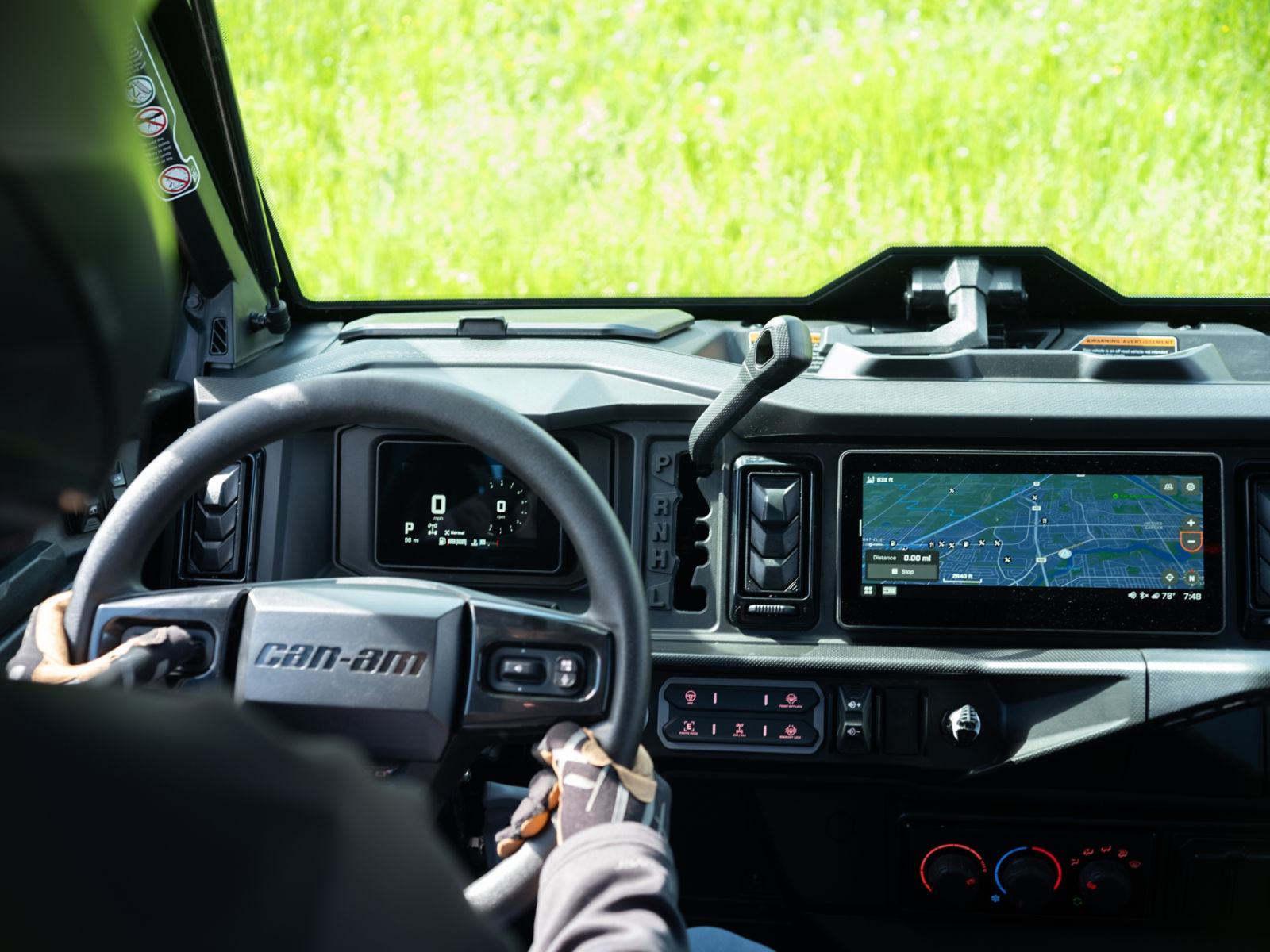 A rider inside a Can-Am side-by-side vehicle using its displays