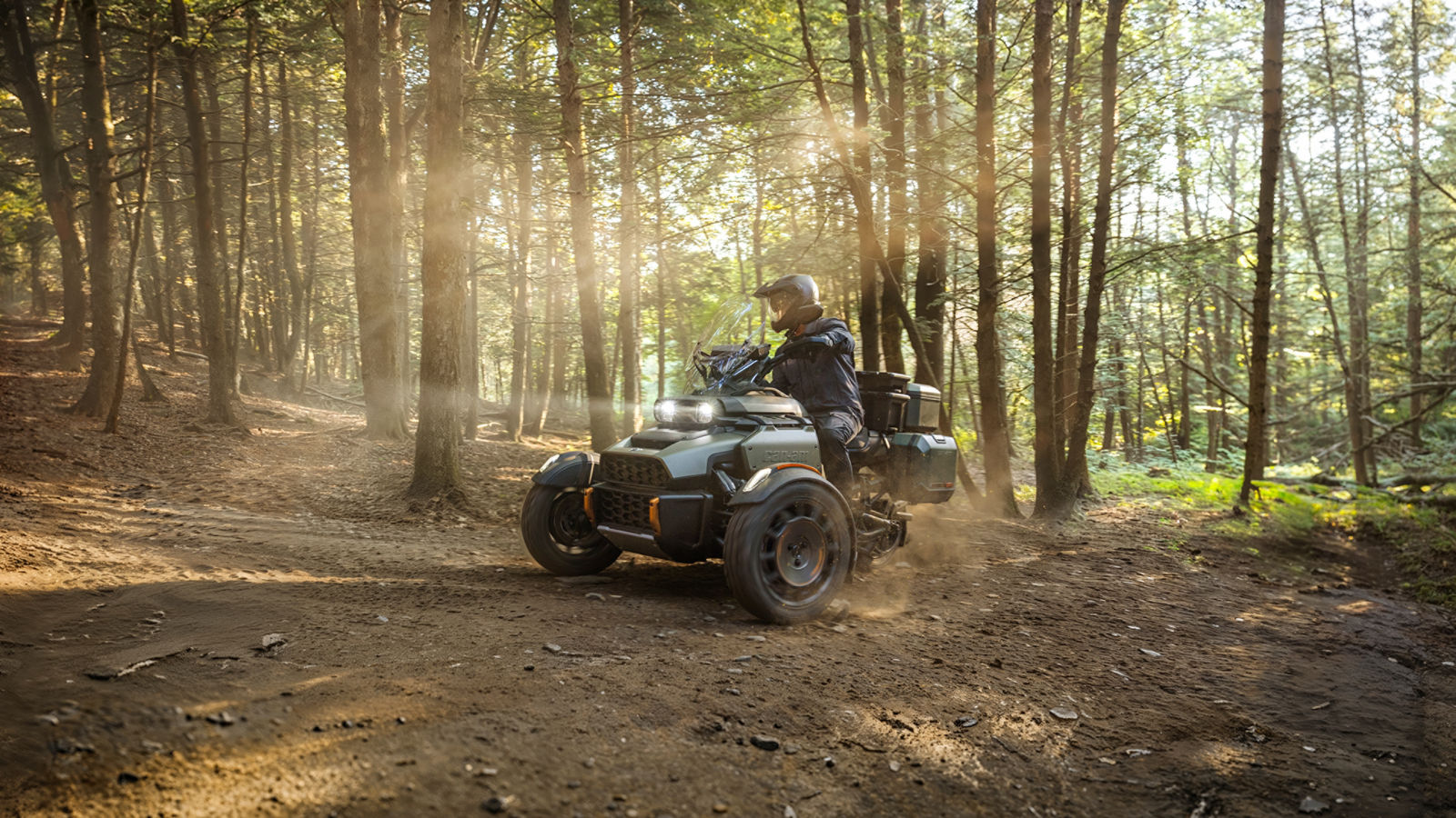 A rider on his Can-Am Canyon three-wheel motorcycle in a forest