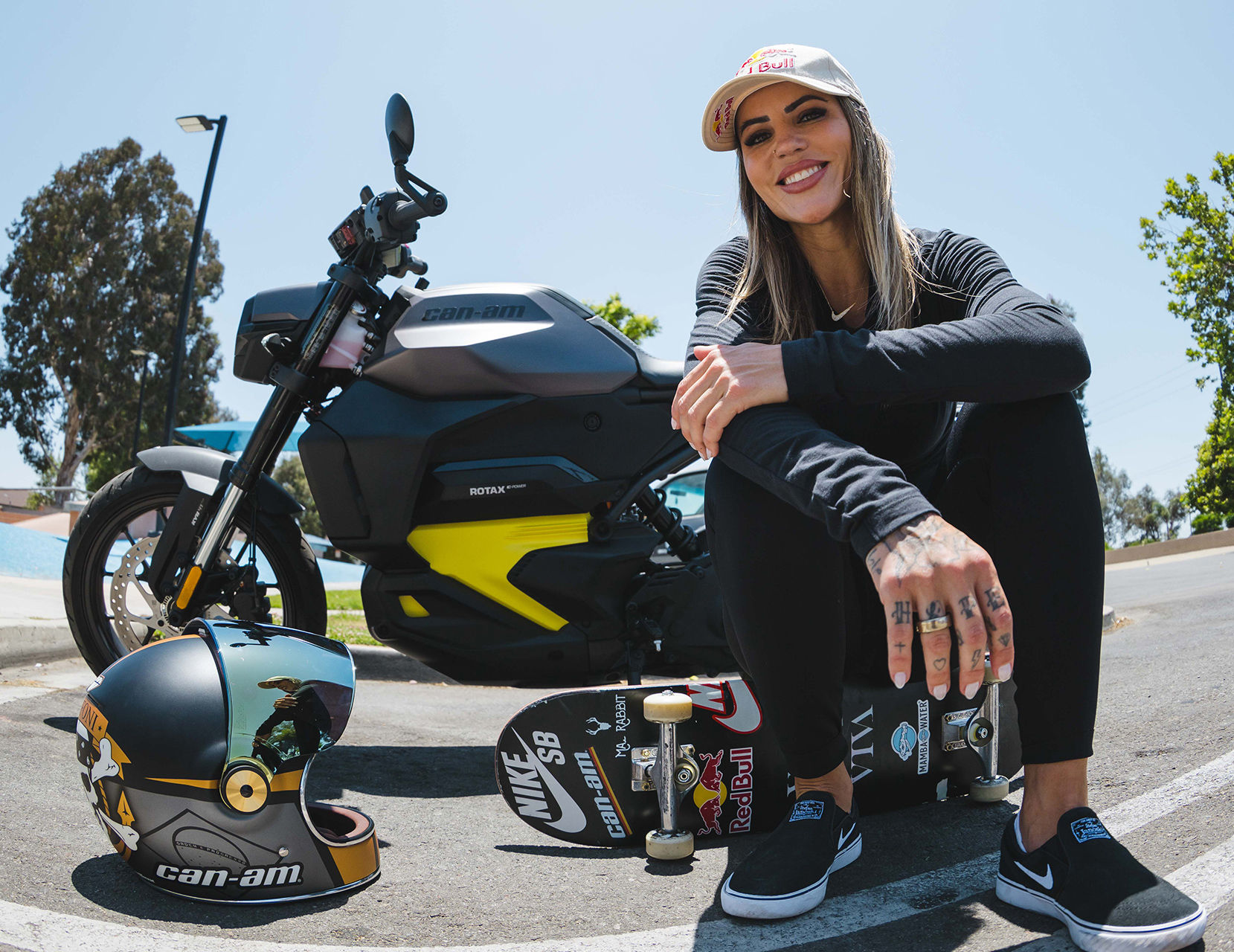 Leticia Bufoni sitting in front of her Can-Am Pulse electric motorcycle