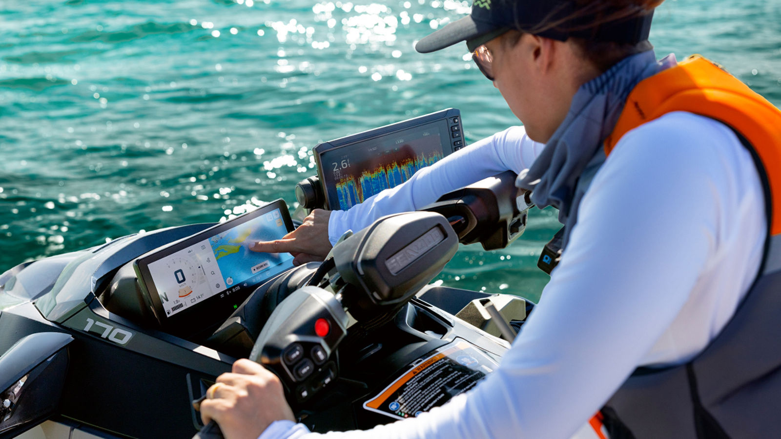 A driver using the touchscreen and sensor on her Sea-Doo personal watercraft
