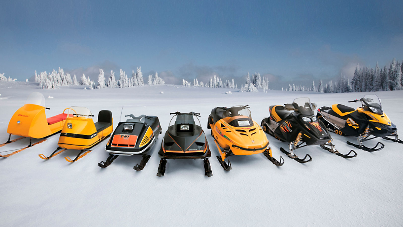 All snowmobiles designed by Ski-Doo over the years, placed side by side on the snow