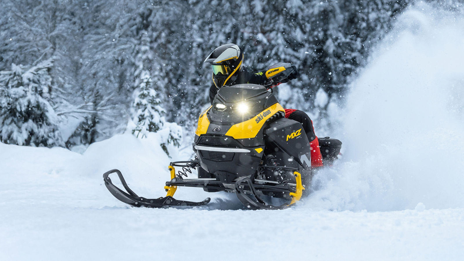 A rider on his Ski-Doo MXZ Neo snowmobile in the mountains