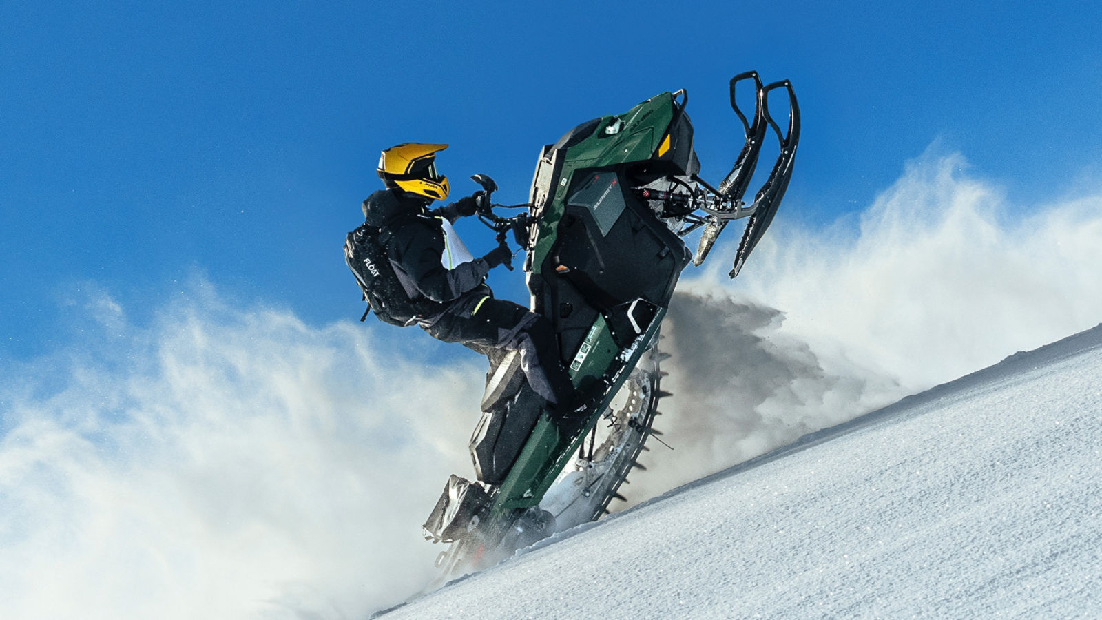 A rider performing tricks on his Ski-Doo Summit snowmobile