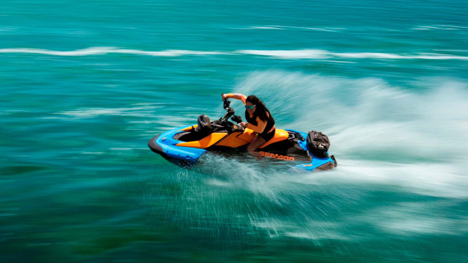 Person making a tight turn with a Sea-Doo on turquoise water