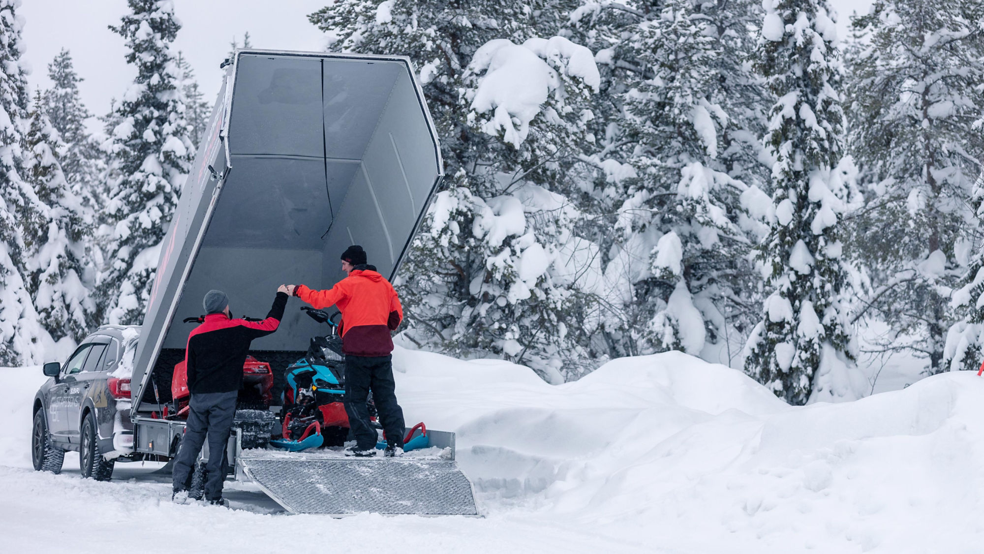 Two Lynx Riders and Snowmobiles in a trailer