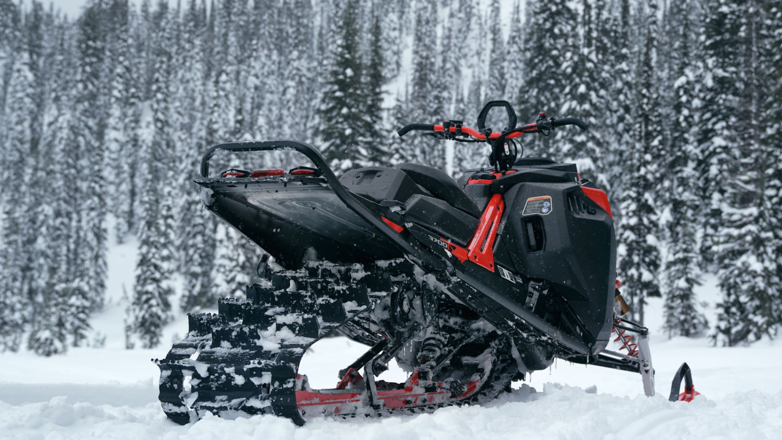 Lynx Shredder-snøscooter sett bakfra parkert i fjellene