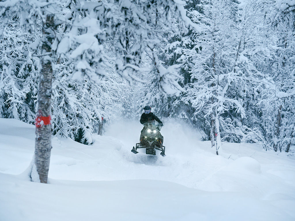 Rider jumping out of deep snow on a 2027 Lynx Brutal RE