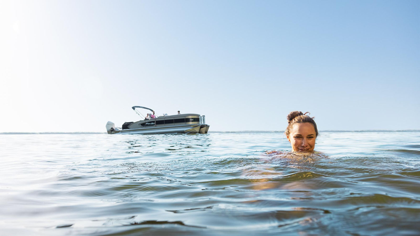 Couple having fun on a Manitou pontoon boat