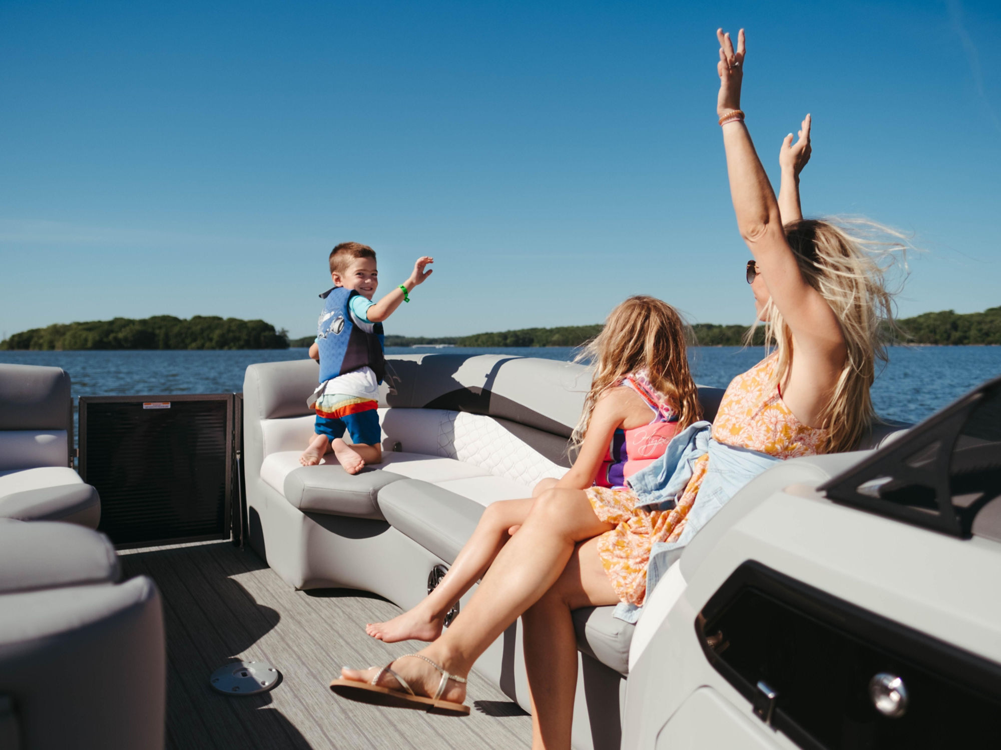 Family on the water with their Manitou Pontoon