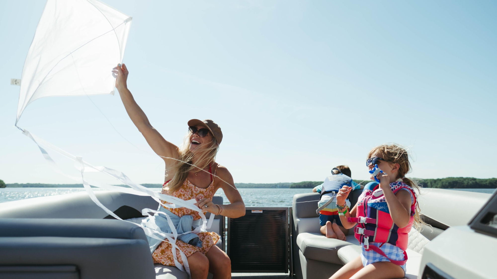 Mother and kids having fun on a Manitou pontoon boat