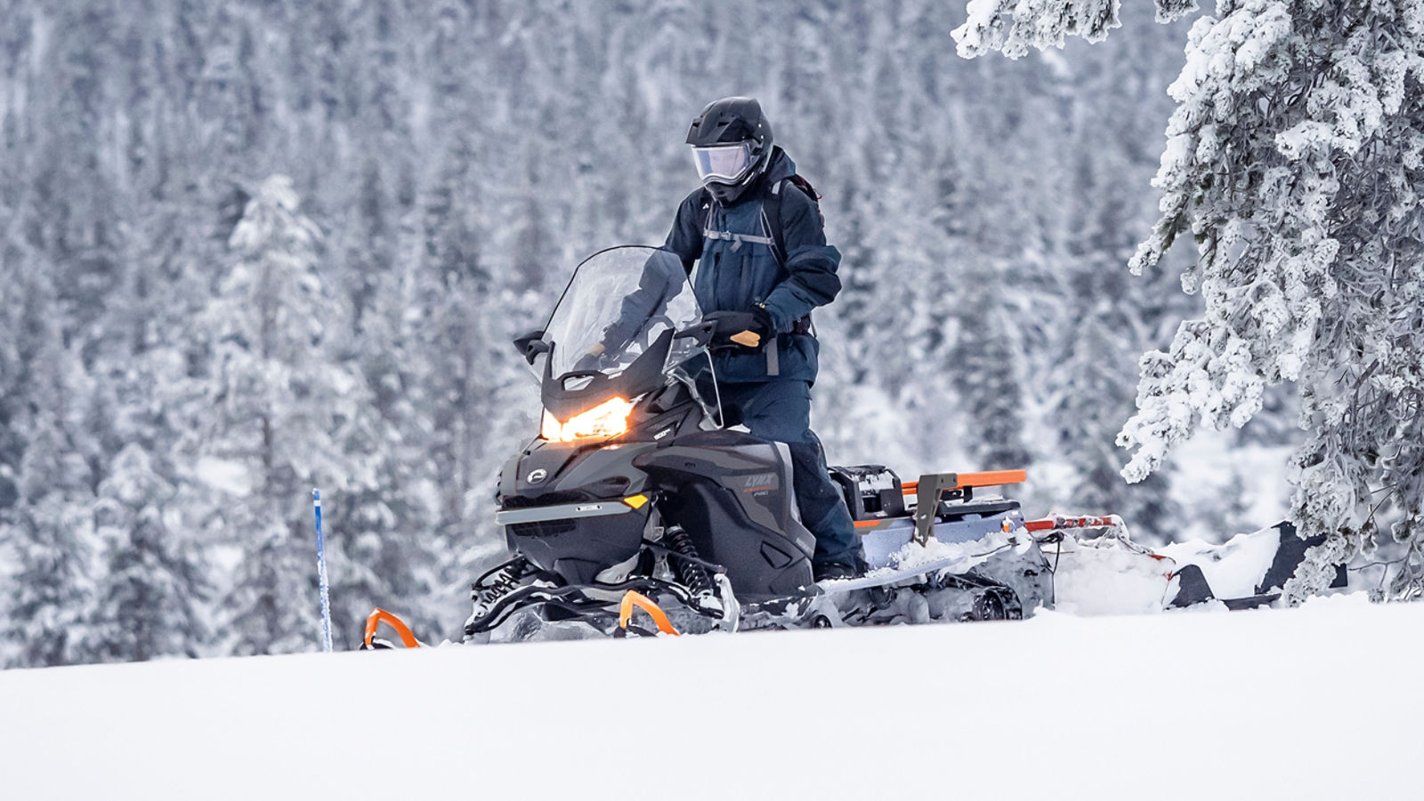 69 Ranger Alpine snowmobile making a trail