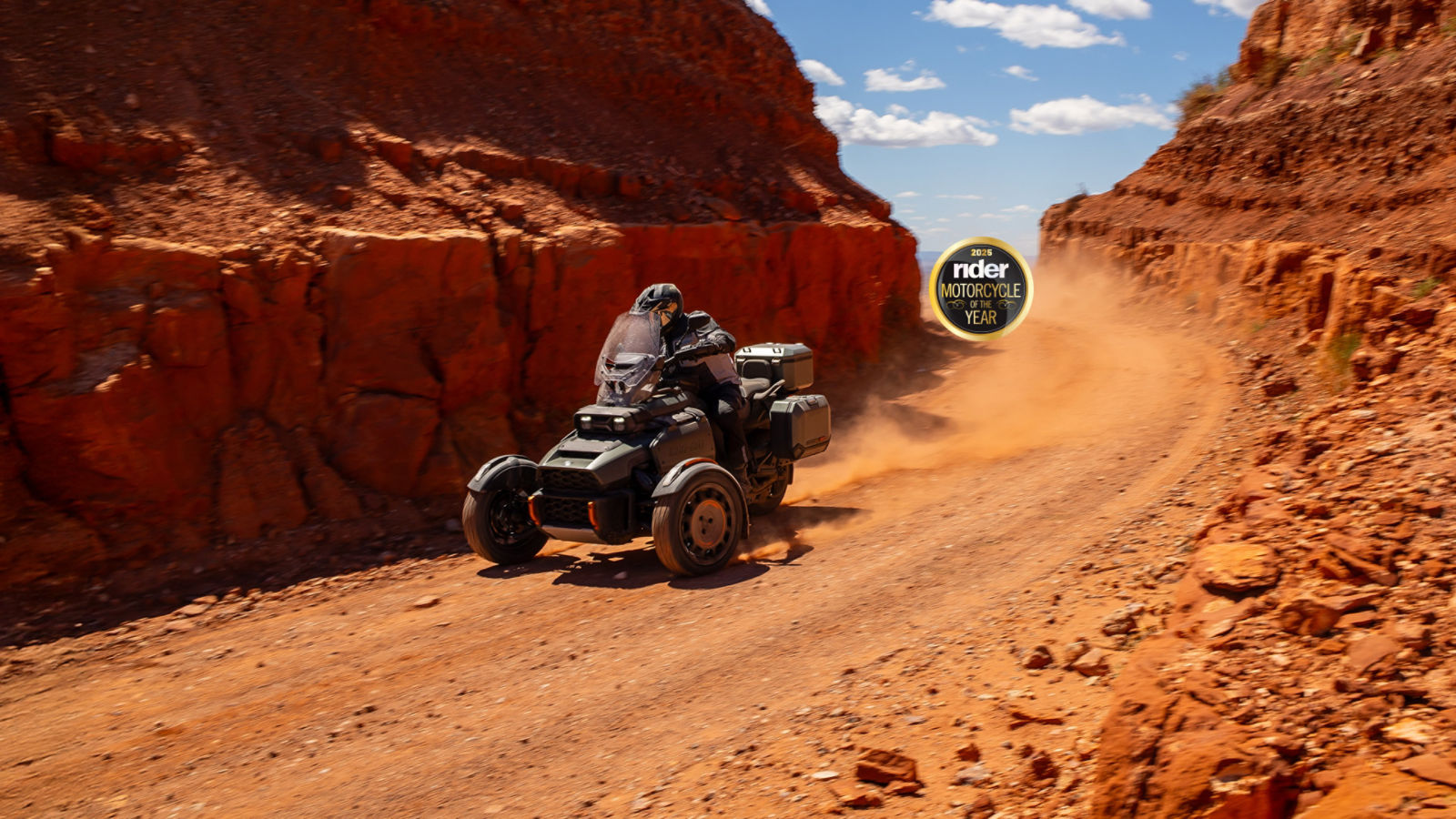 A driver testing a 2025 Can-Am Canyon on a dirt road