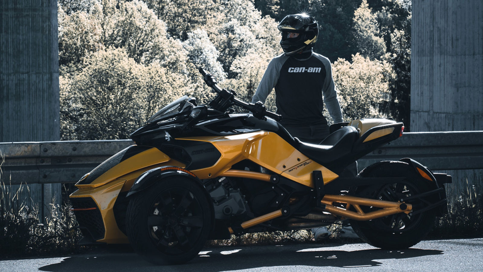 Can-Am Ambassador Nico Dambeck next to his Spyder three-wheeler on a road