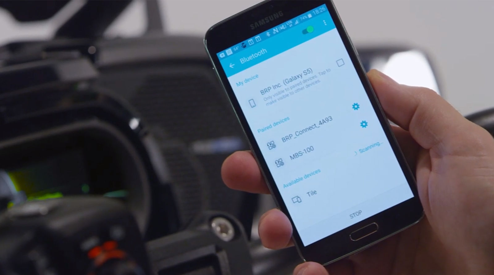 Hand holding smartphone near dashboard 