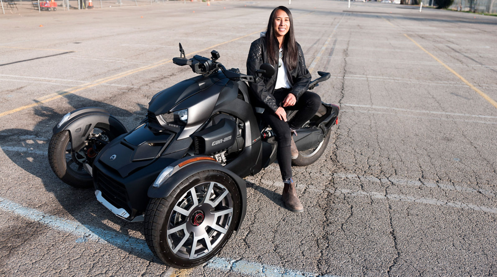 Woman leading up against vehicle