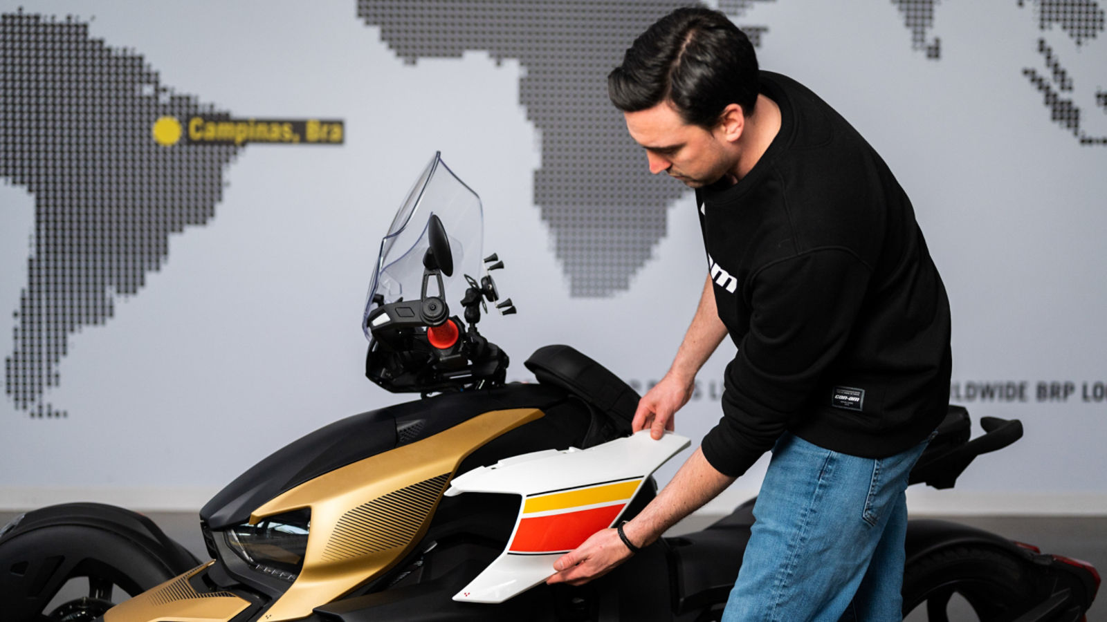Men customizing a Can-Am Ryker vehicle