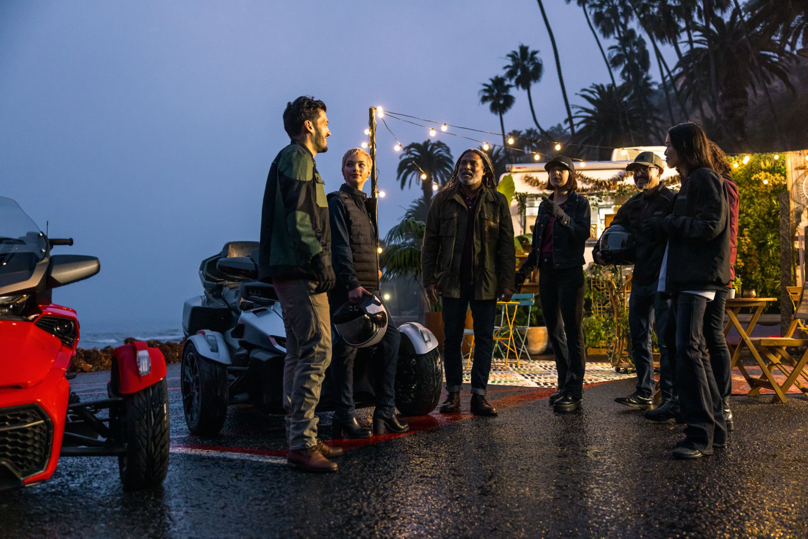 Group of riders and people riding a Can-Am 3 Wheel Vehicle