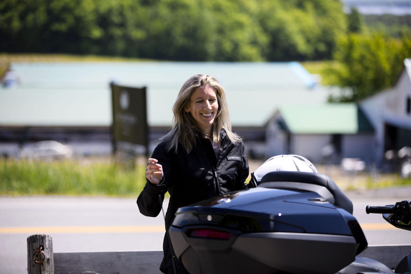 Rider next to a Can-Am Spyder RT 3-wheel vehicle