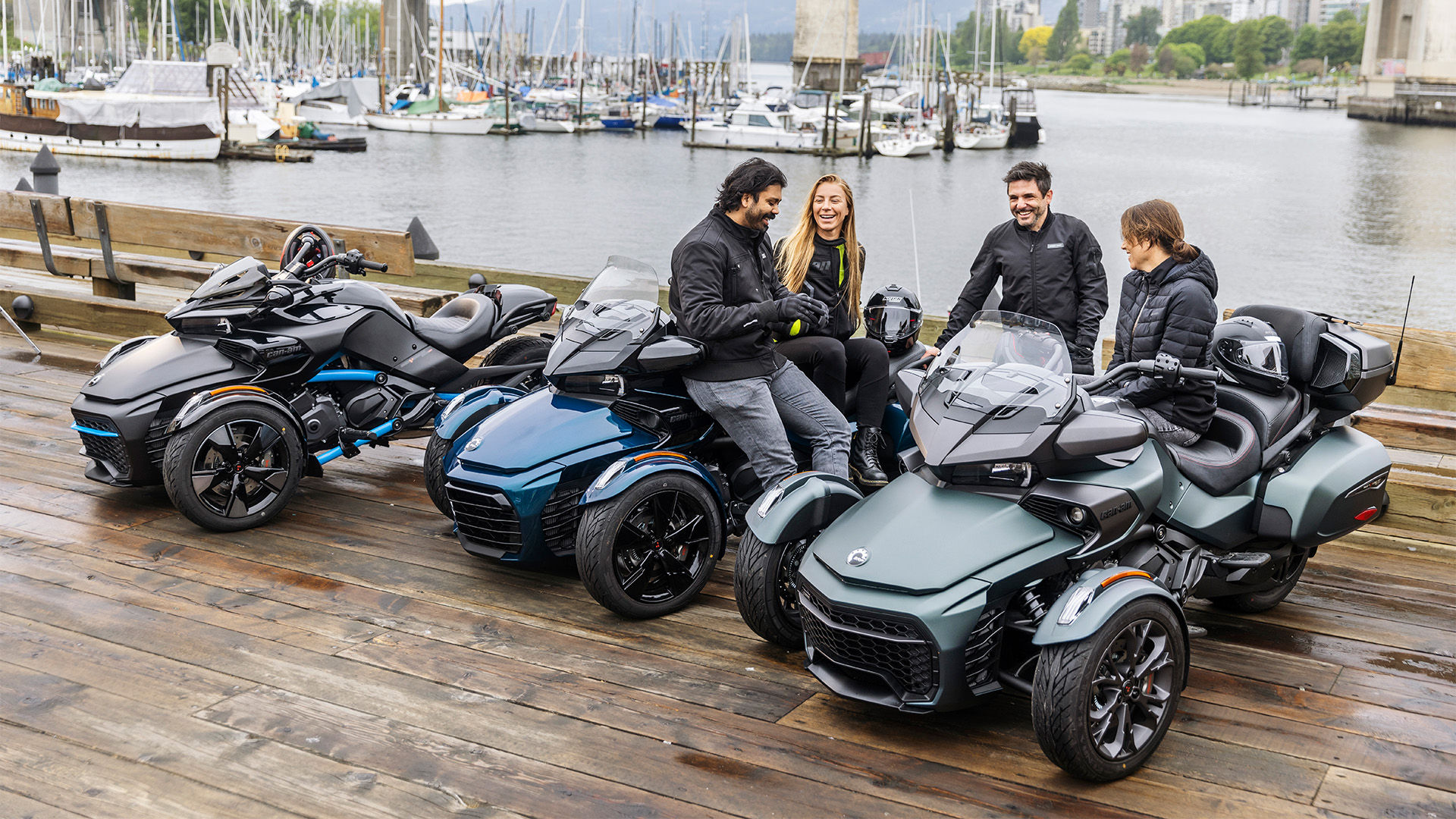 Riders talking and sitting on their Can-Am Spyder F3 vehicles next to a port