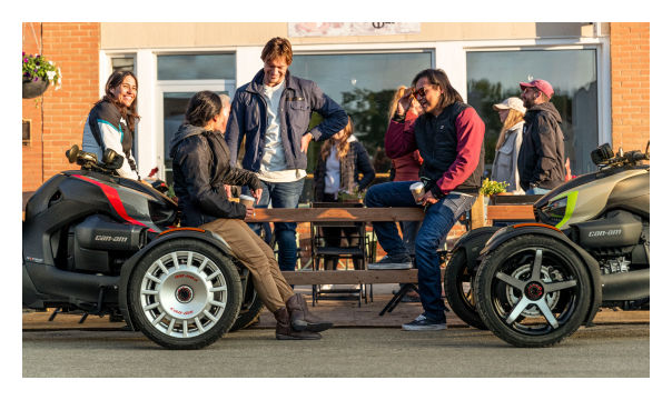 Group of people wearing Can-Am apparels next to their Ryker
