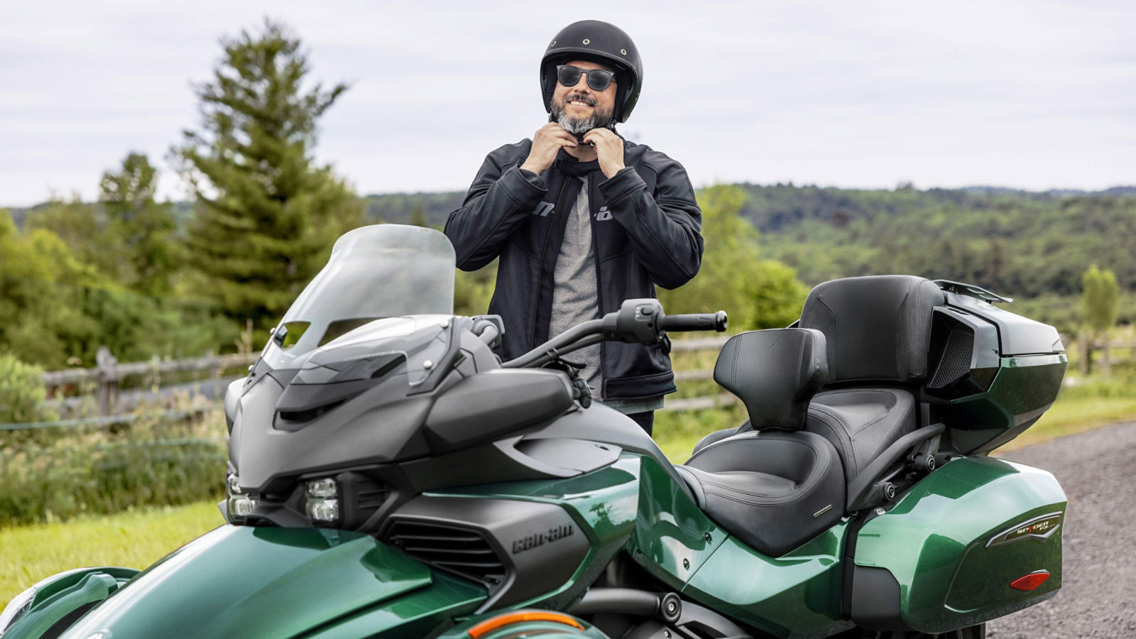Men putting his helmet next to a Can-Am Spyder F3 Limited