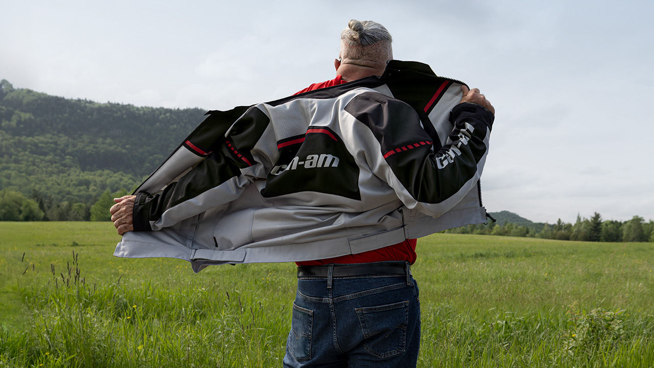 A man taking off his Can-Am motorcycle jacket