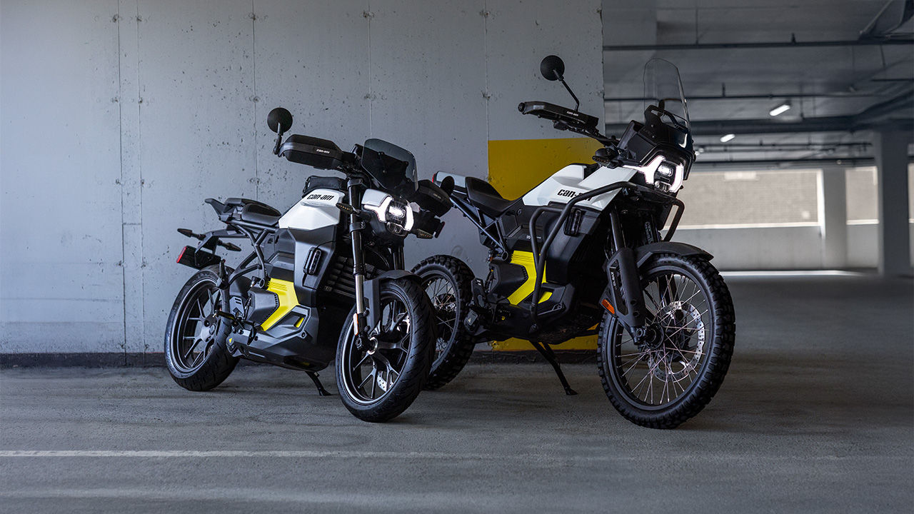 Two Can-Am motorcycles placed next to each other inside a parking