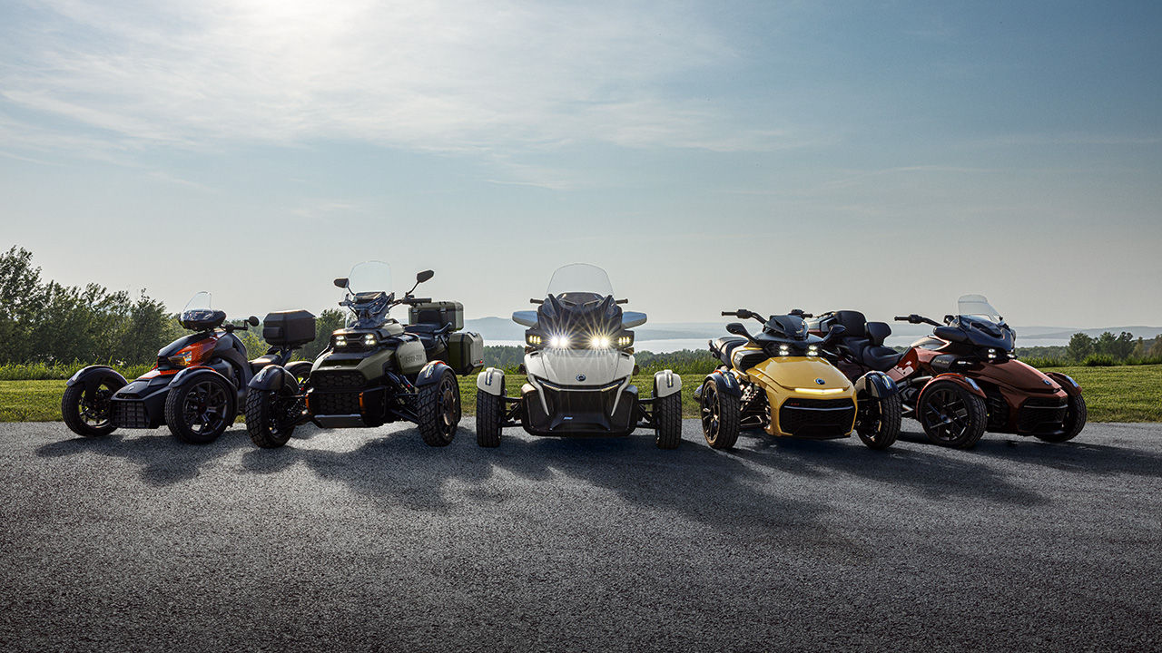 Several new 2026 Can-Am 3-wheel models placed next to each other in front of a field