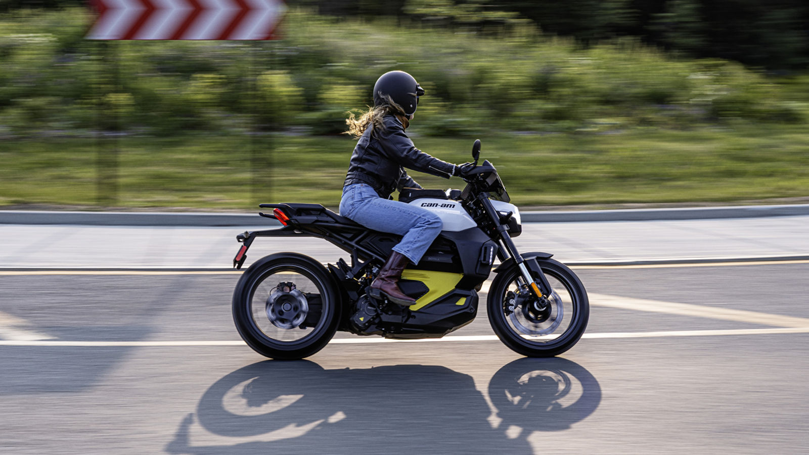 A woman leaning her all-electric Can-Am Pulse to one side while riding