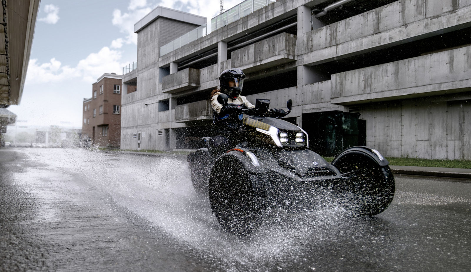 Rider on a 2027 Can-Am Ryker Sport Forged Bronze 3-wheel motorcycle.