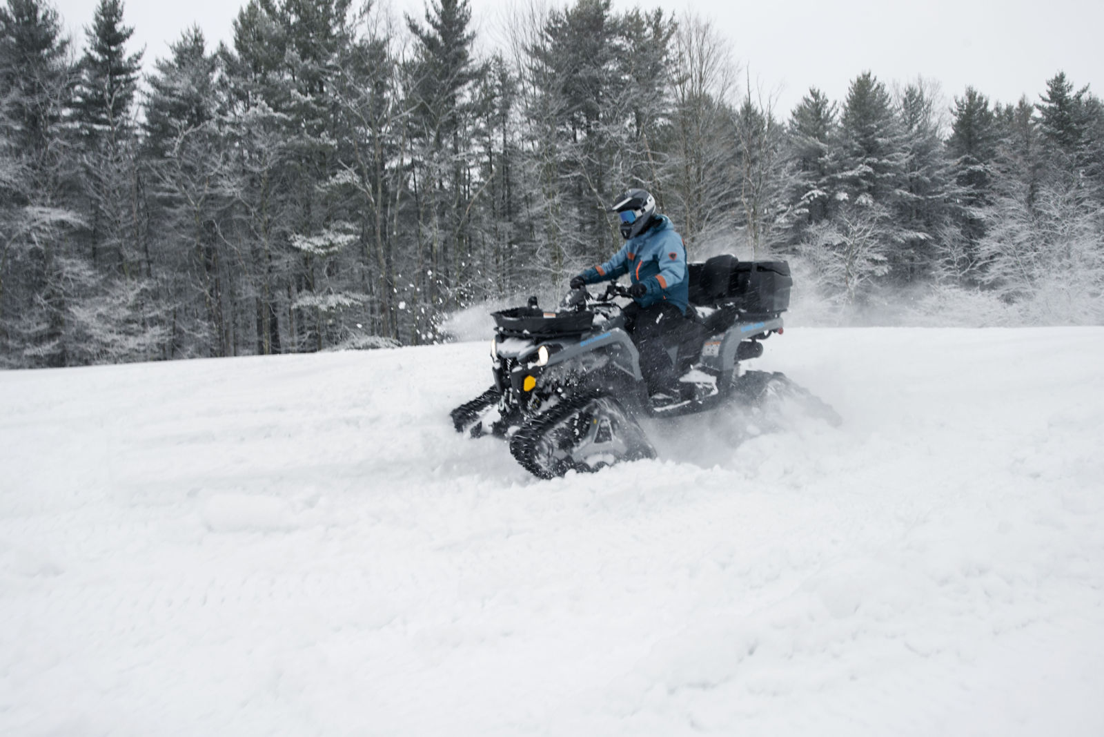 Can-Am ATV riding through the snow thanks to the Apache LT track system
