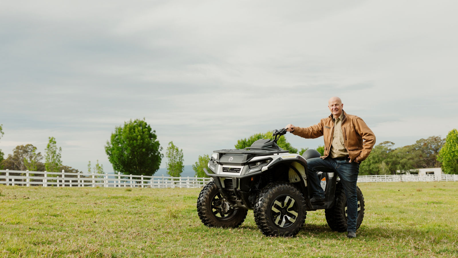 Sir David Fagan standing next to a Can-Am Outlander Electric