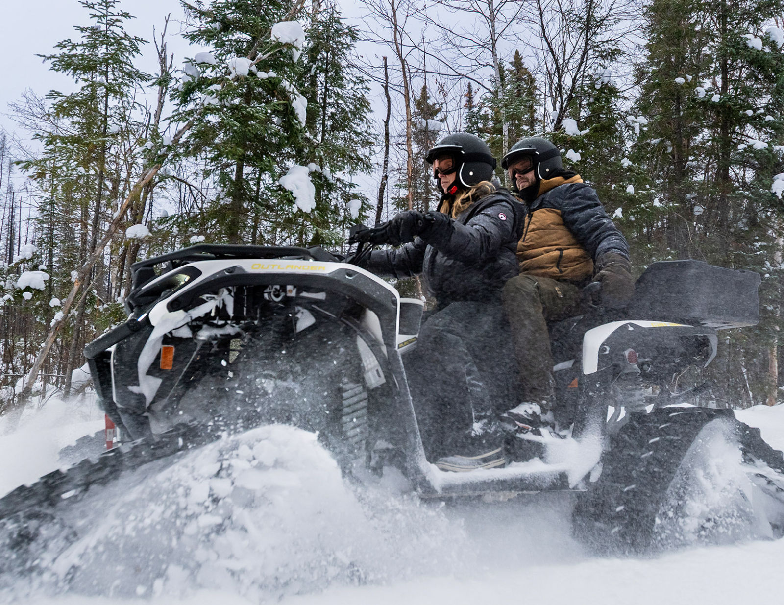 Two people on a Can-Am Outlander in winter