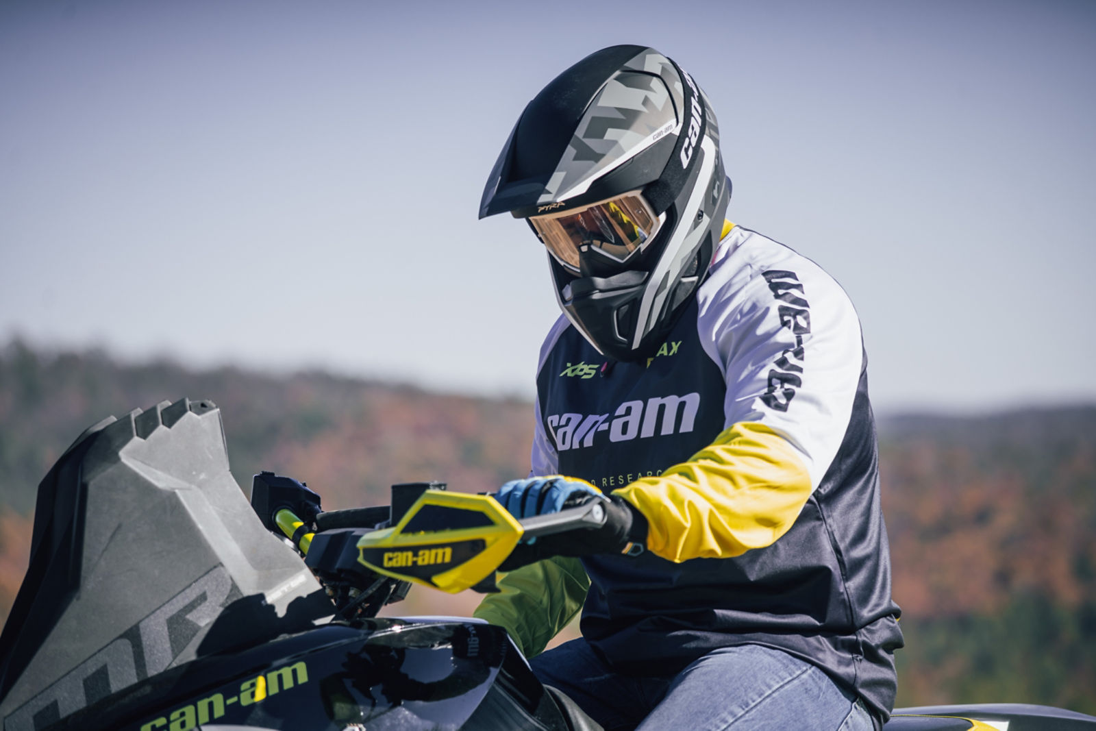 Man closing is linq storage box on can-am maverick