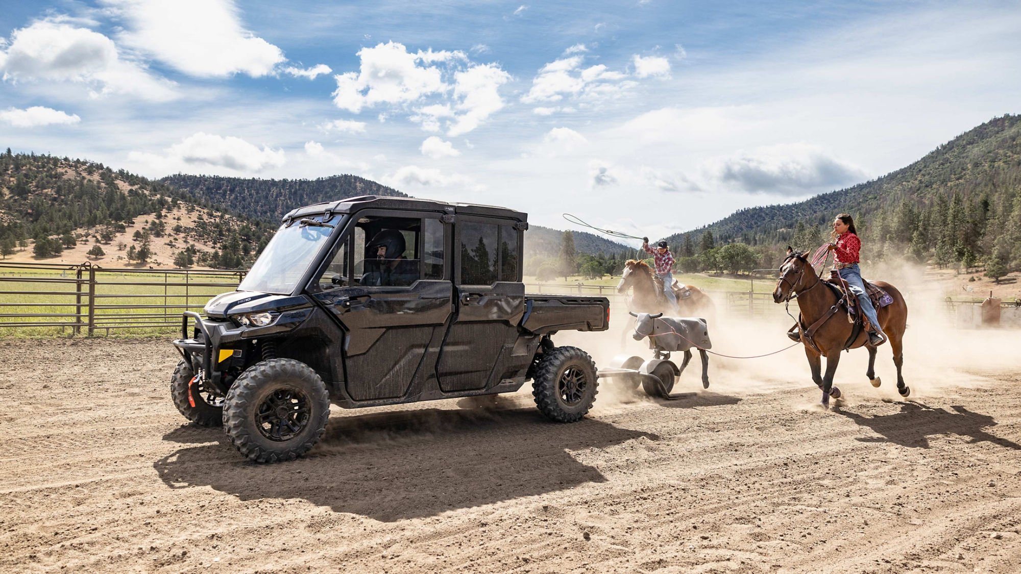 A Can-Am Defender Max 2025 followed by two women on horseback, on the ranch