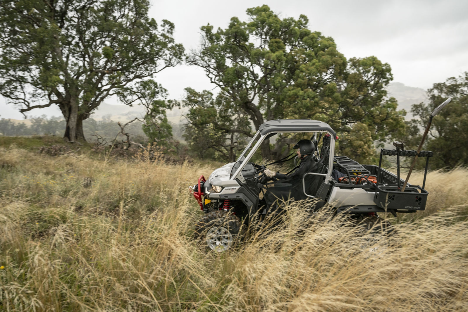 A rider in his 2025 Can-Am Defender XMR riding on his land