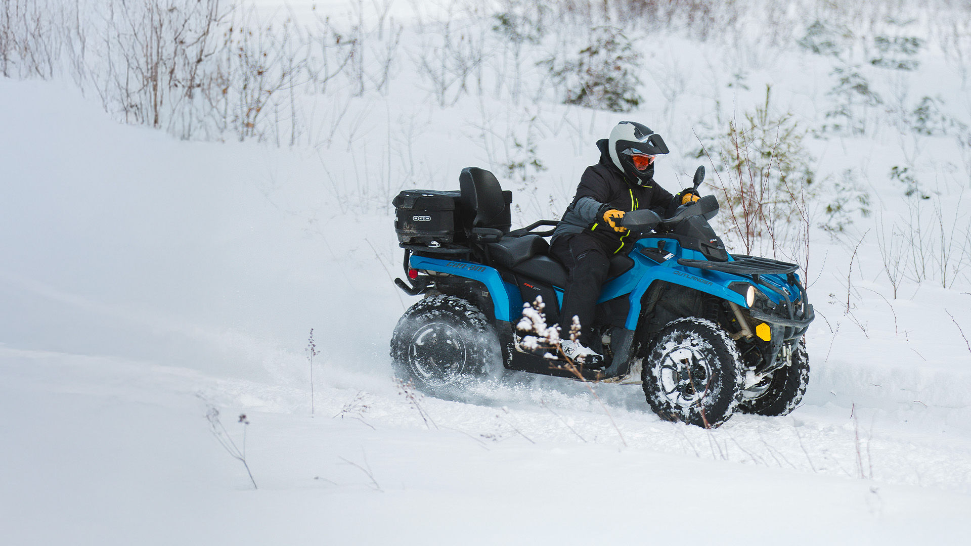 ATV riding snow in the forest