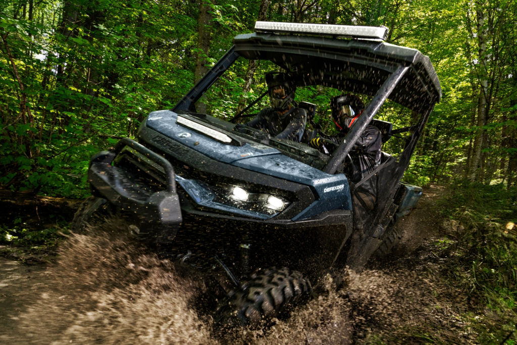 Can-Am Defender driving through mud