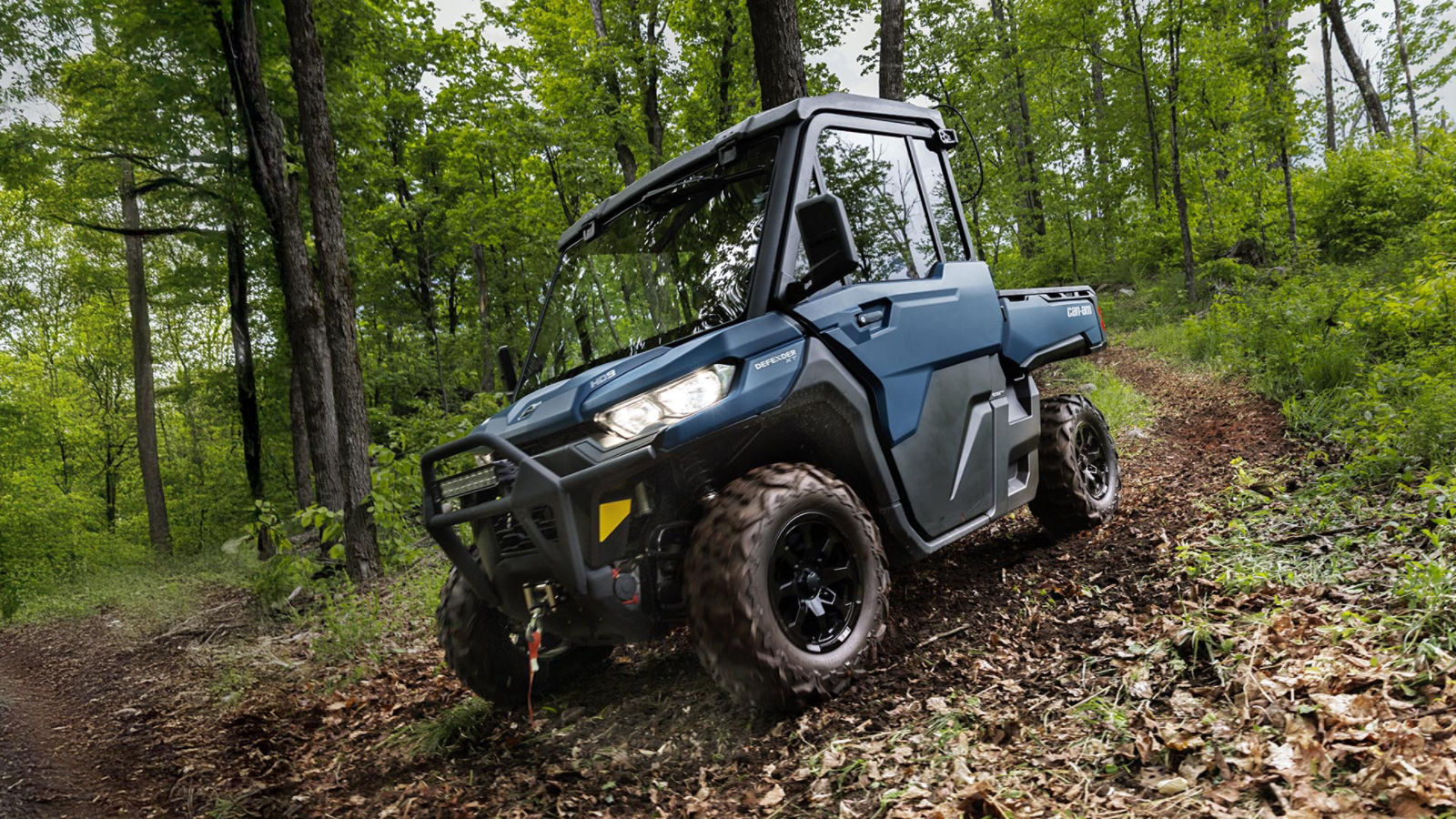 2026 Can-Am Defender XT dusty navy side-by-side in the forest