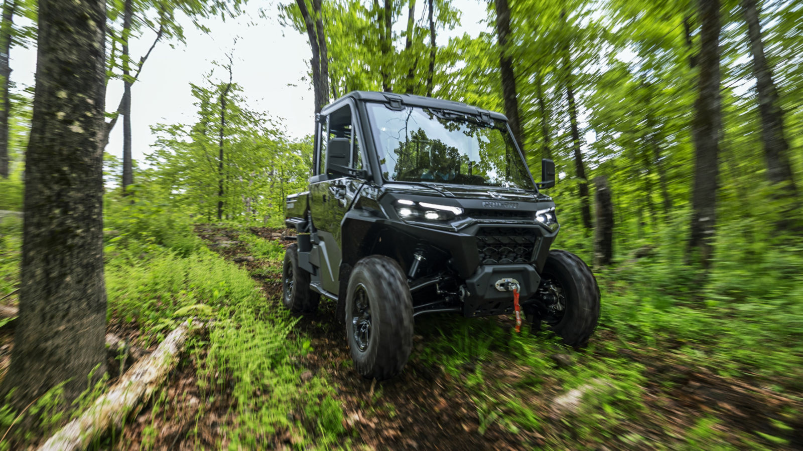 2026 Can-Am Traxter HD11 Stealth Black driving in a forest