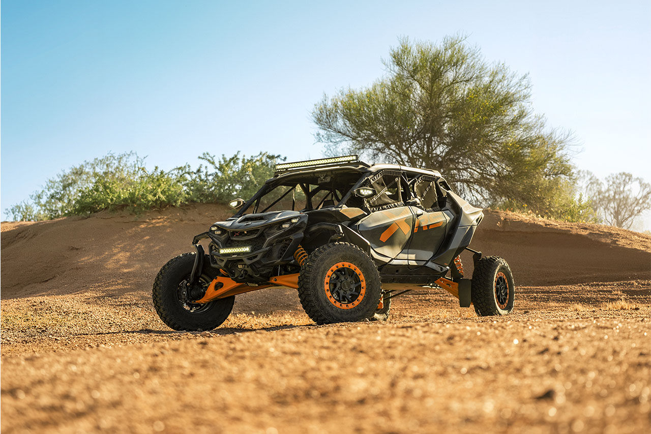 A 2027 Can-Am Maverick R side-by-side vehicle parked in the sand