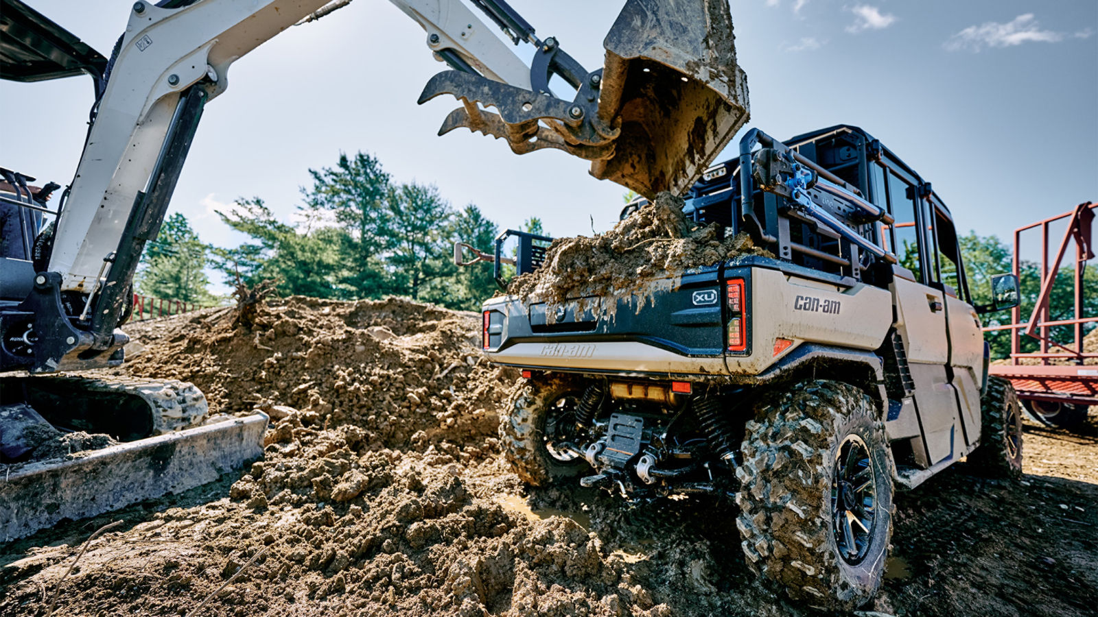 The all-new 2027 Can-Am Defender XU HD10/HD11 having its trunk loaded at a construction site