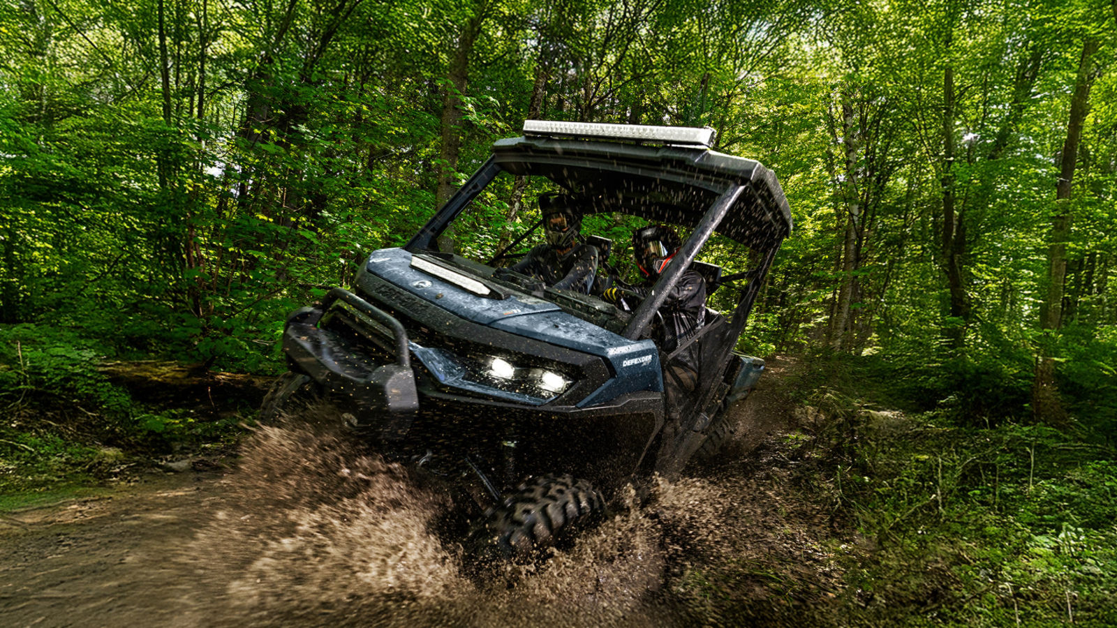 A person standing with a Can-Am SXS 