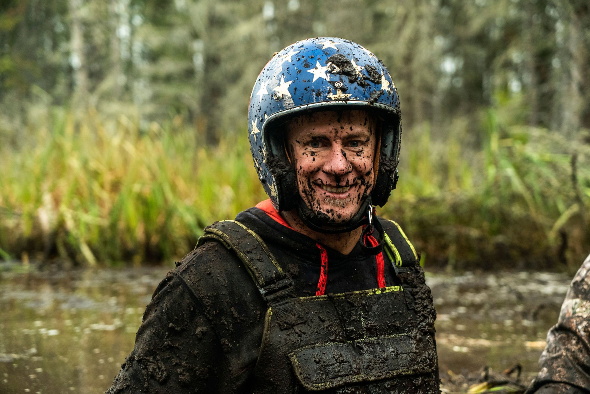Dustin Jones smiling with his badge